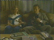Joyce and Giles on sofa with chocolate